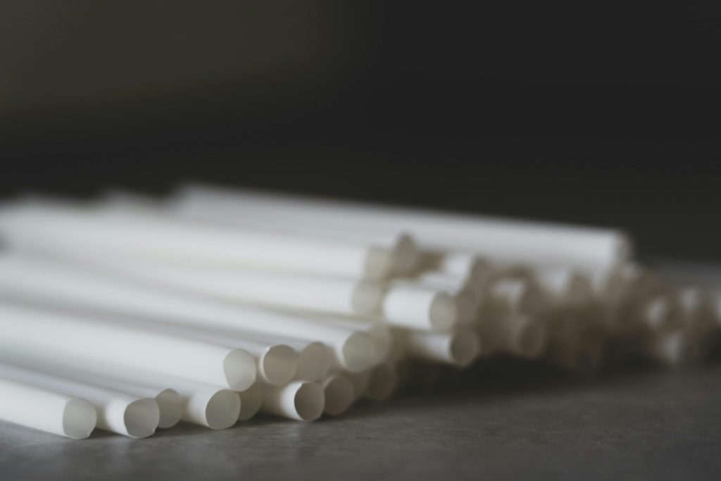 Close-up of eco-friendly paper straws on a dark surface, highlighting sustainability.